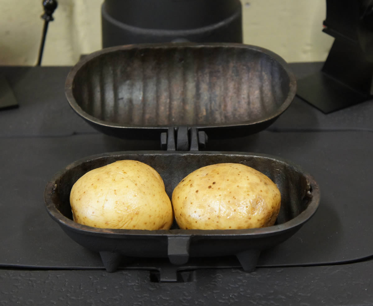 Rare roast beef and baked potatoes in cast iron frying pan Photos